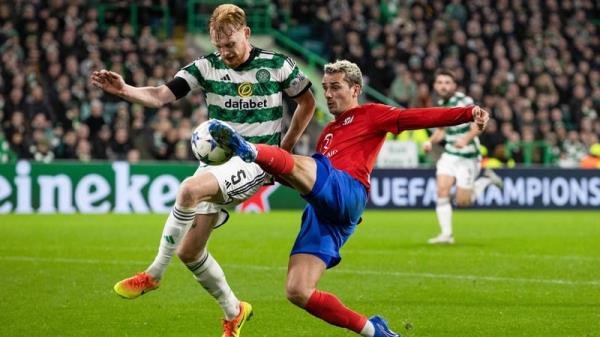 Liam Scales battles for possession with Antoine Griezmann