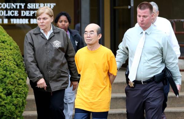 Cook County sheriff deputies escort Camnong Boa-Ubol in Maywood on July 19, 2012. The former Buddhist monk, now 73, was sentenced to 15 years in state prison for luring an underage girl to his Chicago temple and raping her repeatedly over several years. The girl later sued him and the temple and won a $1.2 million settlement. 