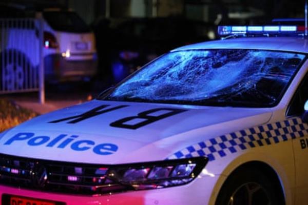 A damaged police car at the scene of the riot.