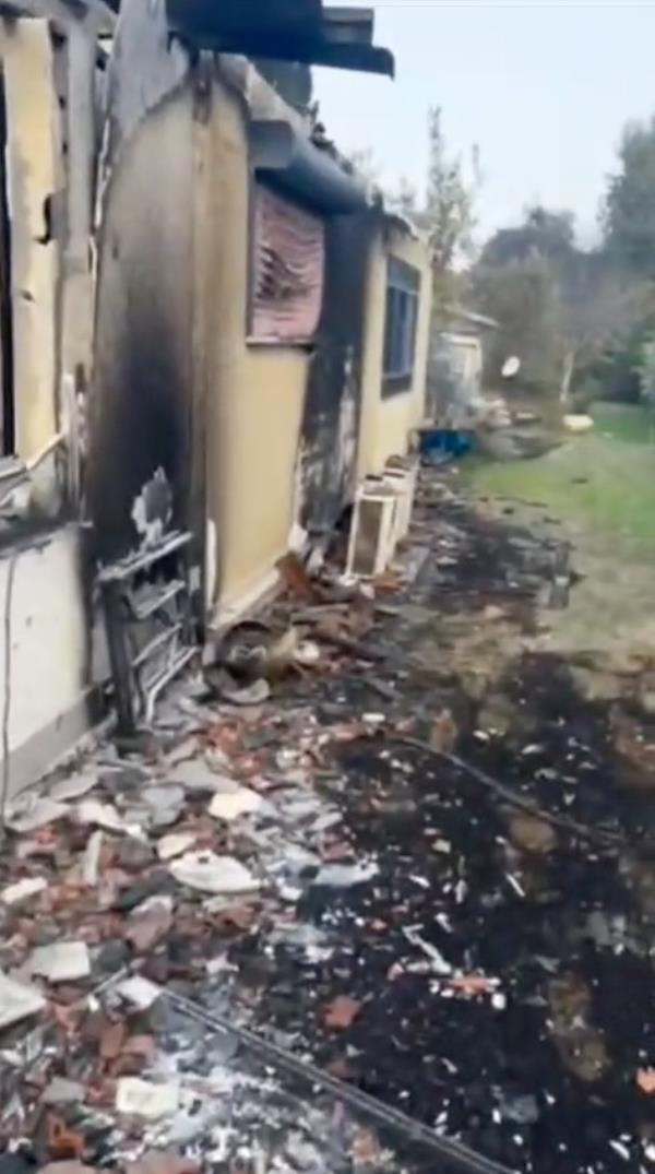 The burned out home of the family of Shaked Haran, who are all missing.