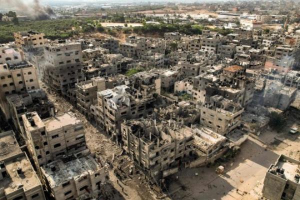 This picture taken on October 11, 2023 shows an aerial view of buildings destroyed by Israeli air strikes in the Jabalia camp for Palestinian refugees in Gaza City. Israel declared war on Hamas on October 8 following a shock land, air and sea assault by the Gaza-ba<em></em>sed Islamists. The death toll from the shock cross-border assault by Hamas militants rose to 1,200, making it the deadliest attack in the country's 75-year history, while Gaza officials reported more than 900 people killed as Israel pounded the territory with air strikes. (Photo by Yahya HASSOUNA / AFP) (Photo by YAHYA HASSOUNA/AFP via Getty Images)