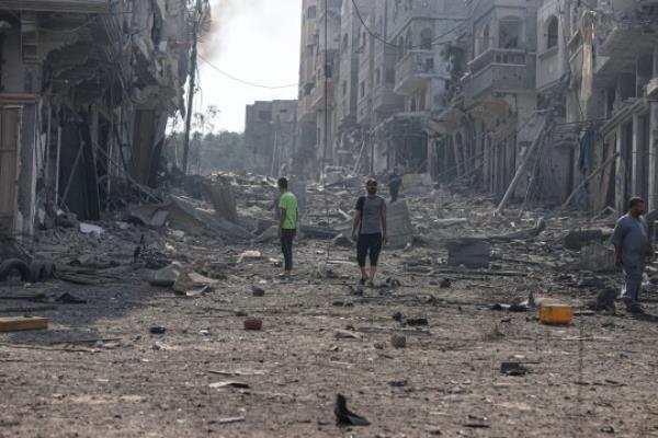 GAZA CITY, GAZA - OCTOBER 11: People are seen around destroyed buildings and debris at the Jabalia neighborhood after an Israeli airstrike that has been going on for five days in Gaza City, Gaza on October 11, 2023. (Photo by Mustafa Hassona/Anadolu via Getty Images)