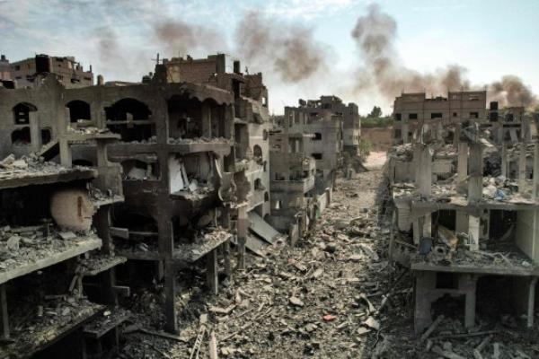 TOPSHOT - This picture taken on October 11, 2023 shows an aerial view of buildings destroyed by Israeli air strikes in the Jabalia camp for Palestinian refugees in Gaza City. Israel declared war on Hamas on October 8 following a shock land, air and sea assault by the Gaza-ba<em></em>sed Islamists. The death toll from the shock cross-border assault by Hamas militants rose to 1,200, making it the deadliest attack in the country's 75-year history, while Gaza officials reported more than 900 people killed as Israel pounded the territory with air strikes. (Photo by Yahya HASSOUNA / AFP) (Photo by YAHYA HASSOUNA/AFP via Getty Images)