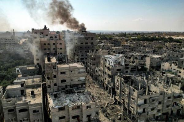 TOPSHOT - This picture taken on October 11, 2023 shows an aerial view of buildings destroyed by Israeli air strikes in the Jabalia camp for Palestinian refugees in Gaza City. Israel declared war on Hamas on October 8 following a shock land, air and sea assault by the Gaza-ba<em></em>sed Islamists. The death toll from the shock cross-border assault by Hamas militants rose to 1,200, making it the deadliest attack in the country's 75-year history, while Gaza officials reported more than 900 people killed as Israel pounded the territory with air strikes. (Photo by Yahya HASSOUNA / AFP) (Photo by YAHYA HASSOUNA/AFP via Getty Images)