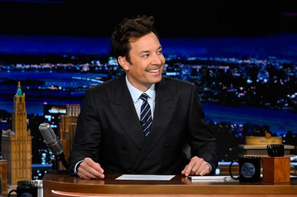 Jimmy Fallon at his desk. 