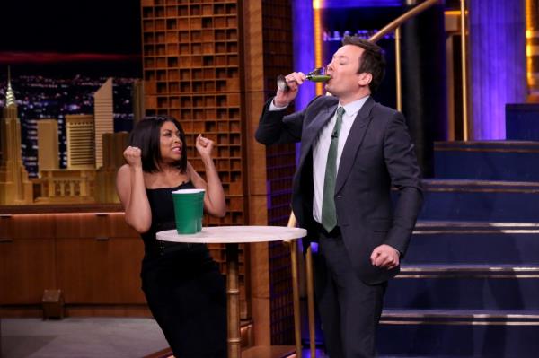 Jimmy Fallon drinking onstage. 