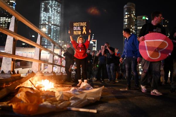 Protesters block the Ayalon highway during a demo<em></em>nstration calling for the release of hostages as well as denouncing the government and Israeli Prime Minister Benjamin Netanyahu