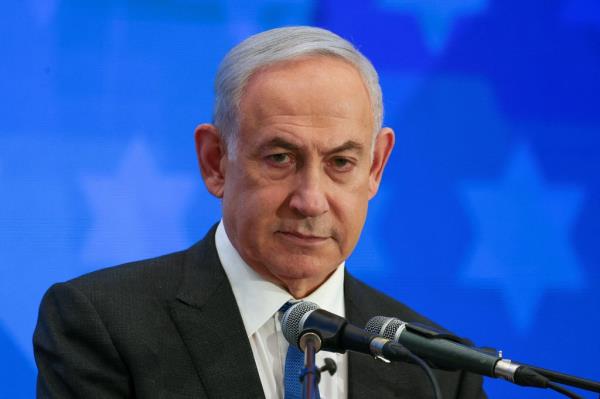 Israeli Prime Minister Benjamin Netanyahu speaks at a podium.