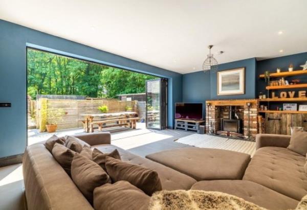 The Haven's bifold doors and large L shaped sofa. 