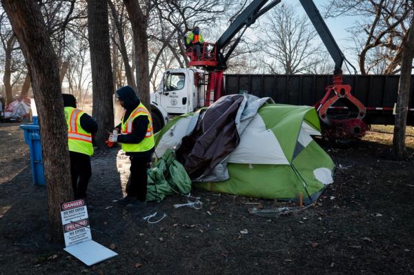 City workers clearing a large homeless encampment in Humboldt Park, Chicago on a December morning in 2024, with homeless people being moved to shelters or apartments