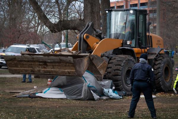 Workers with a bulldover removing the tents from Humboldt Park on Dec. 6, 2024.