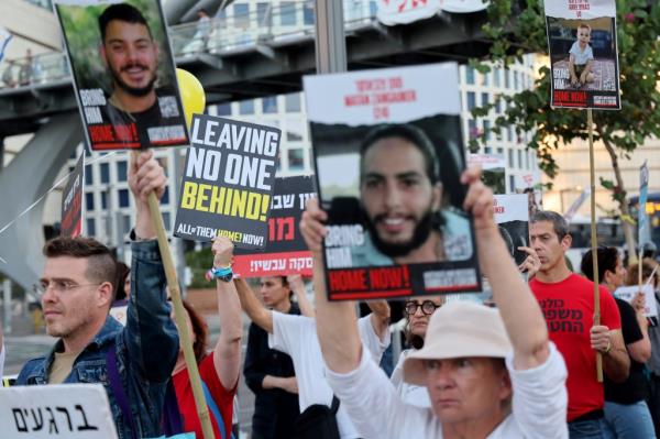 Demo<em></em>nstrators holding signs at a rally outside the defence ministry headquarters in Tel Aviv, calling for the release of Israeli hostages held in Gaza