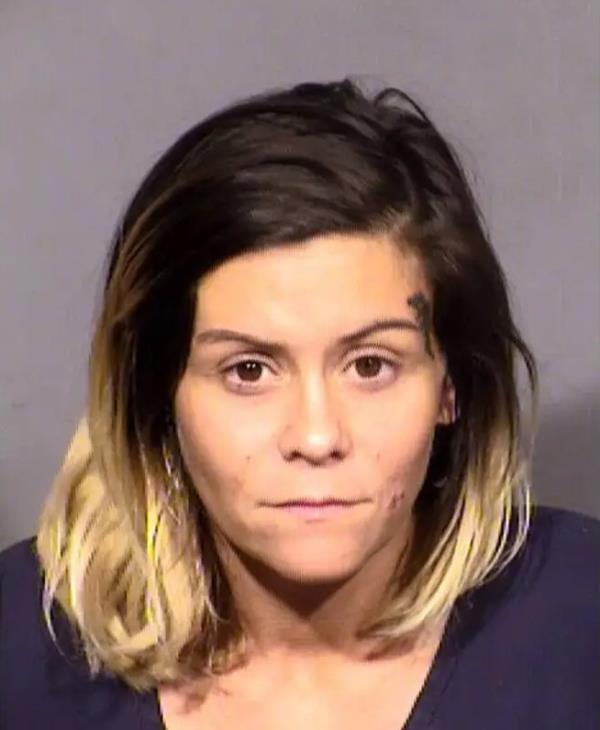 Video grabs from police body cam footage shown by KLAS shows Las Vegas Metro police rescuing six children a one-bedroom, one-bathroom extended-stay apartment near Flamingo Road and Valley View Boulevard. Travis Doss, 31, and Amanda Stamper, 33, were arrested and charged. 