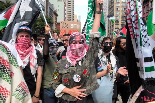 Pro-Palestine demo<em></em>nstrators waving flags during a rally in Manhattan, New York City, with Shikha Uberoi present among the crowd.