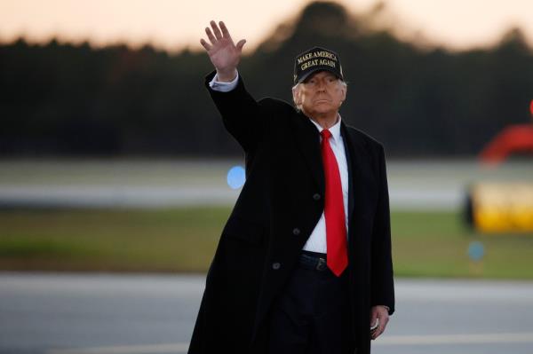 Former President Trump waves to supporters at the co<em></em>nclusion of a campaign rally at Kinston Regio<em></em>nal Jetport in North Carolina. 