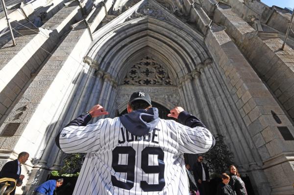 Yankees fan Harrison Lindman, 24, from Lake George, stopped in St. Patrick's Cathedral to say a prayer for a win before heading to the Bronx to see tonight's game. 