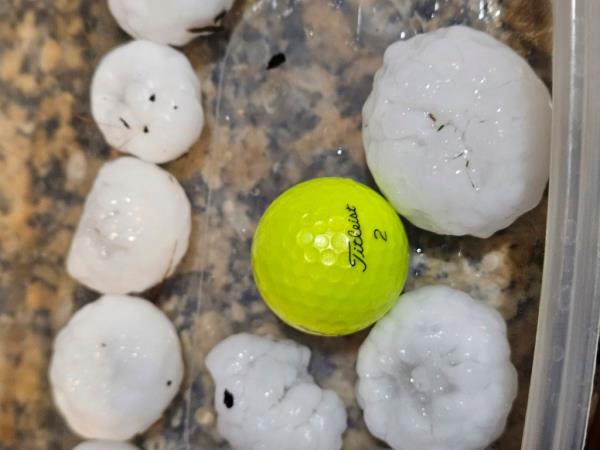 This image shows large chunks of hail compared to the size of a golf ball, on Wednesday night, March 13, 2024, in Shawnee, Kan. 