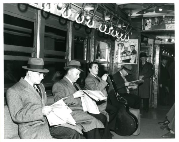 Commuters on a vintage NYC subway. 