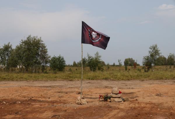 A view shows a flag of the Wagner private mercenary group at the site of the plane crash that killed Wagner PMC top figures, including Yevgeny Prigozhin and Dmitry Utkin