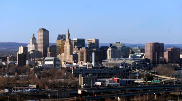 Aerial view of Hartford, Co<em></em>nnecticut skyline on the west bank of the Co<em></em>nnecticut river, highlighting financial struggles