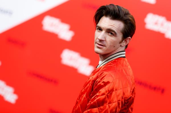 Drake Bell in a red jacket attending the premiere of Lionsgate's 