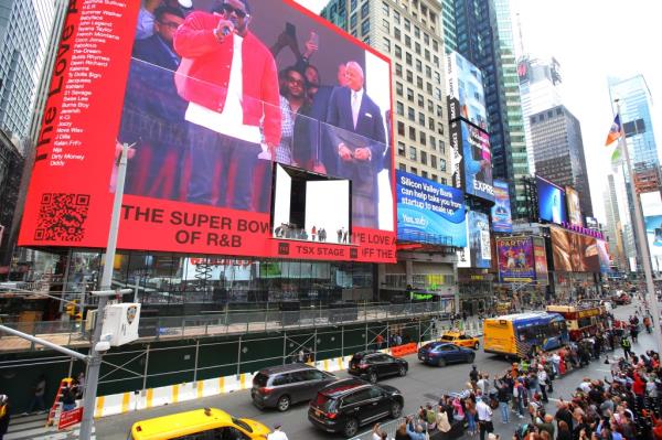 Times Square celebrating Sean Combs Key to the City award from Mayor Adams. Crowds and billboards seen.