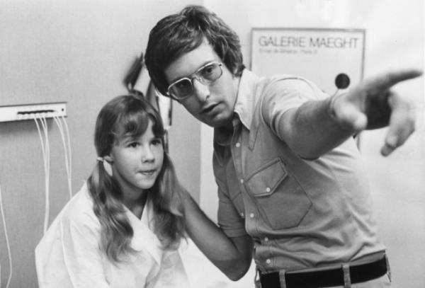 8th February 1974: Film director William Friedkin explaining the next scene to Linda Blair during the making of the Exorcist