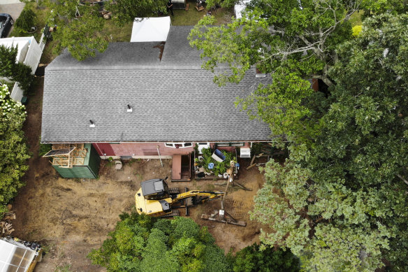 Investigators comb through the home of Rex Heuermann.