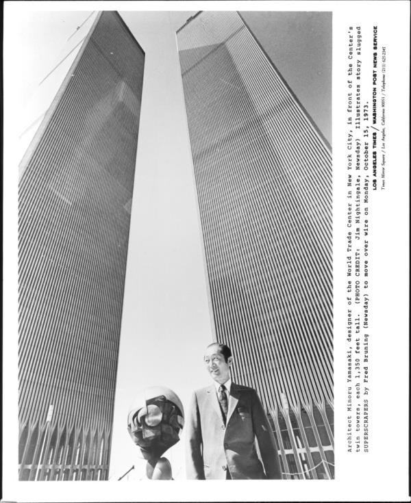 Architect Minoru Yamasaki, designer of the World Trade Center in New York city, in front of the Center's twin towers, each 1,350 feet tall. 