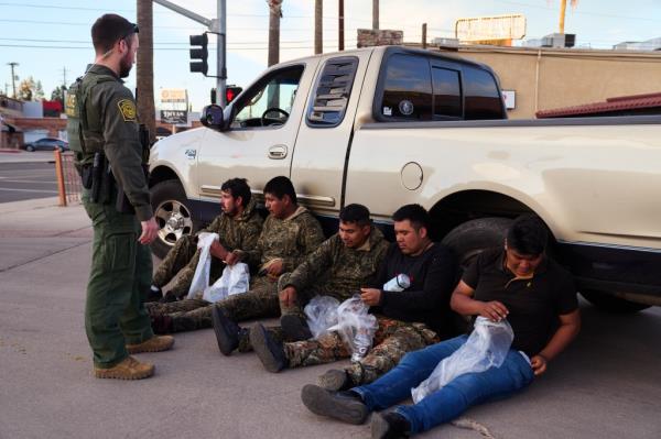 Suspected illegal immigrants wearing the kind of camouflage clothing frequently provided by cartels who have been paid to arrange crossings into the United States 