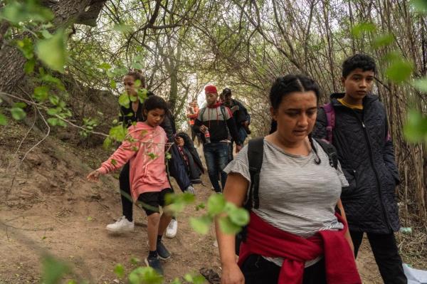 Migrants from Venezuela walk towards the Rio Grande river to cross from Mexico into the U.S. Piedras Negras, Mexico on Dec. 21, 2023.