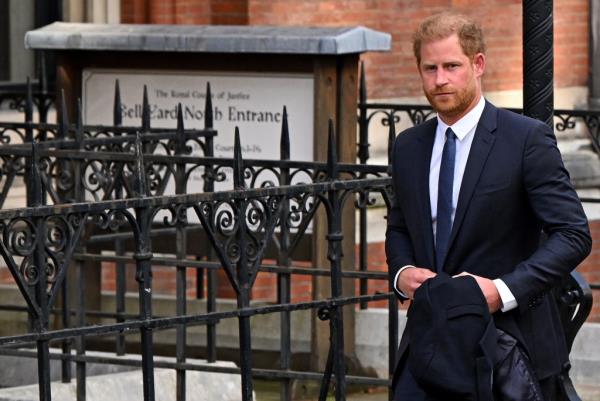 Prince Harry in a suit leaving the High Court in central London.