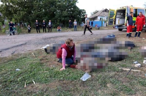 EDS NOTE: GRAPHIC Co<em></em>nTENT - In this photo provided by the Ukrainian Presidential Press Office, a woman reacts near the bodies of victims of the deadly Russian rocket attack that killed at more than 40 people in the village of Hroza near Kharkiv, Ukraine, Thursday, Oct. 5, 2023. (Ukrainian Presidential Press Office via AP)