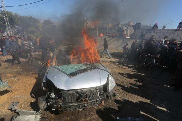 Palestinians watching a car burn after it was hit during Israeli shelling in Rafah in the Gaza Strip on Feb. 4, 2024.