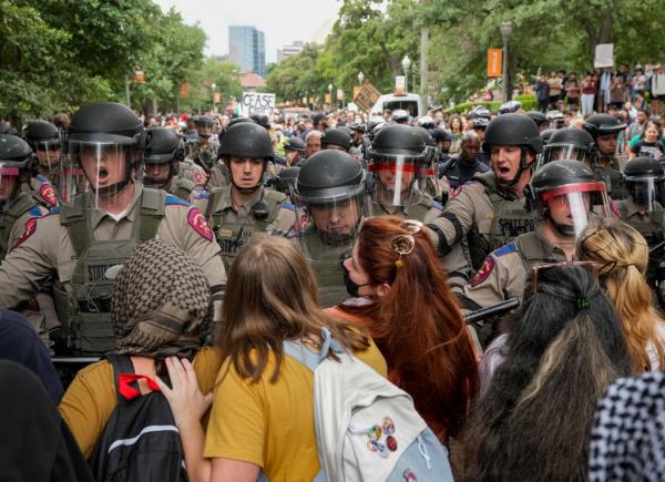 Texas state troopers in riot gear try to break up a pro-Palestinian protest at the University of Texas, Wednesday, April 24, 2024, in Austin, Texas. 