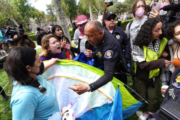 University of Southern California protesters fight with University Public Safety officers as they try to remove tents at the campus' Alumni Park during a pro-Palestinian occupation on Wednesday, April 24, 2024 in Los Angeles. 