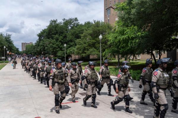 Police officers encircled the dwindling group, which sat in defiance of an earlier warning to disperse or be arrested. 