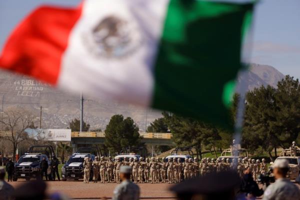 Members of the Mexican army and police officers participate in the commemoration of Flag Day in Ciudad Juarez, Mexico, February 24, 2022