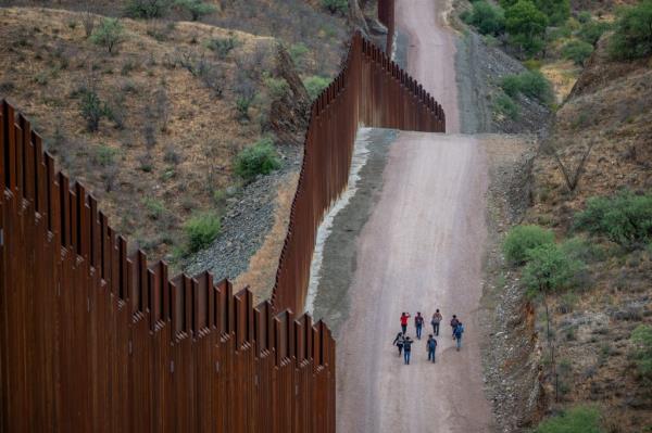 Migrants seeking asylum from Central and South America walk alo<em></em>ngside border fencing after illegally crossing over into the U.S. on June 24, 2024 in Ruby, Arizona