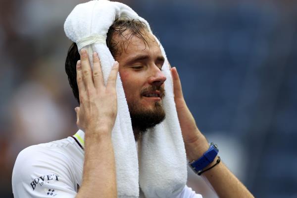 Daniil Medvedev tries to cool off with a towel.