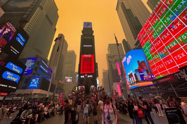 Times Square takes on an eerie orange glow in the wake of wildfires in Canada.