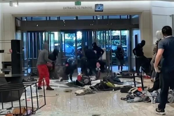 Pictured is group of masked robbers trasheing and robbing a Macy's in Sherman Oaks, California. 