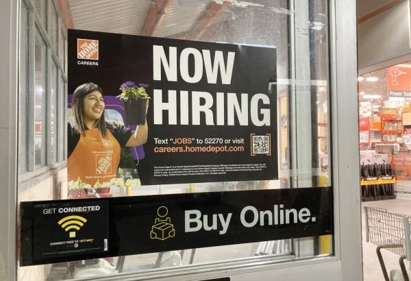 A general view of a now hiring sign as seen at a Home Depot store in Passaic, NJ on November 27, 2023. 