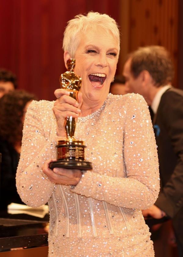 Jamie Lee Curtis holding her Oscar. 