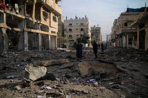 Palestinian citizens inspect damage to their homes caused by Israeli airstrikes in the Karama area, northern Gaza Strip October 11, 2023 in Gaza City, Gaza.