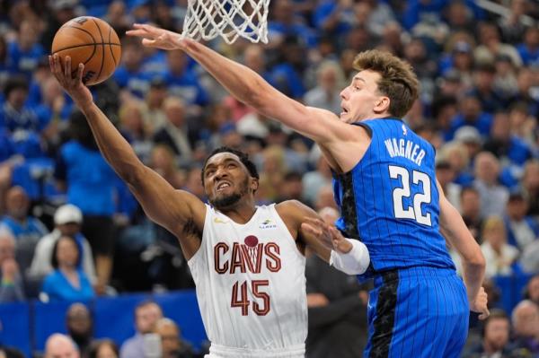 Cleveland Cavaliers guard Do<em></em>novan Mitchell (45) takes a shot around Orlando Magic forward Franz Wagner (22) during the first half of Game 6 of an NBA basketball first-round playoff series, Friday, May 3, 2024, in Orlando, Fla. 