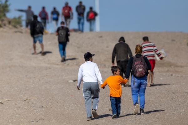 Immigrants from Venezuela walk towards a U.S. Border Patrol transit center after crossing the Rio Grande into the United States.