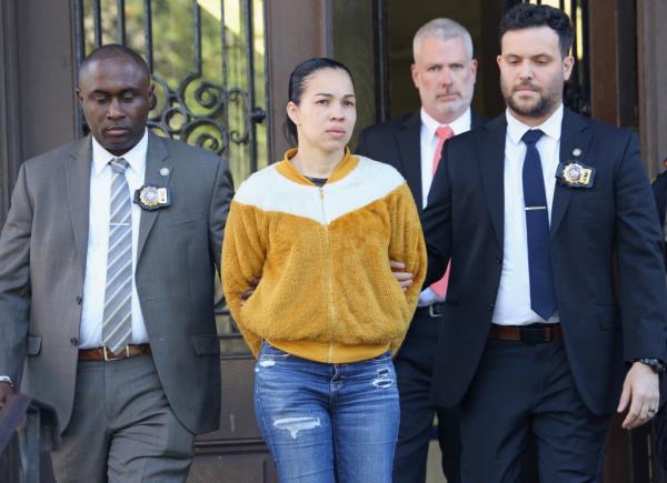 Grei Mendez De Ventura in handcuffs walking out of the 52nd NYPD precinct