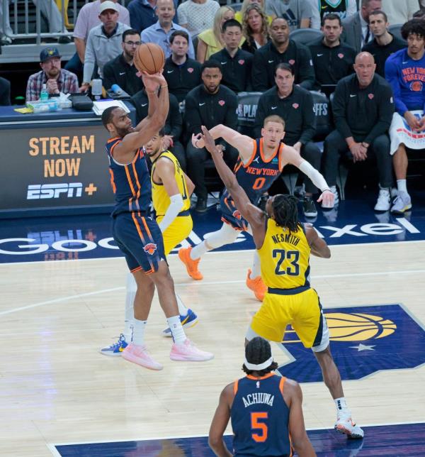 Alec Burks #18 of the New York Knicks puts up a shot over Aaron Nesmith #23 of the Indiana Pacers during the second quarter.