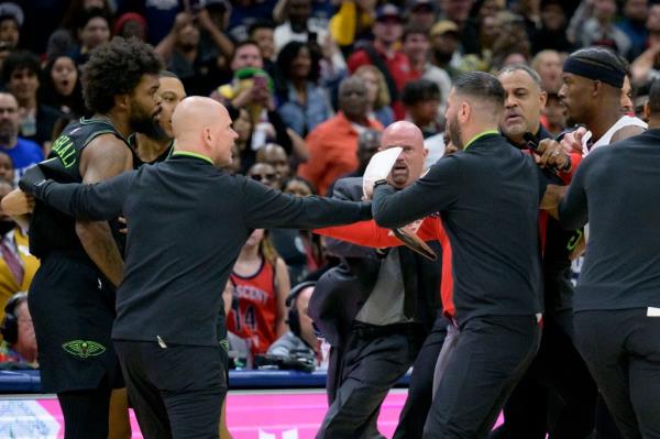 Pelicans forward Naji Marshall and Miami Heat forward Jimmy Butler get into a scuffle during the second half of an NBA basketball game.